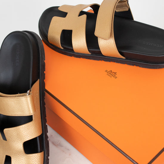 Gold and black sandal on orange 'Hermes' box