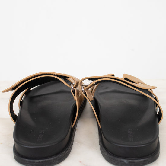 Heel of black and gold sandal on marble surface