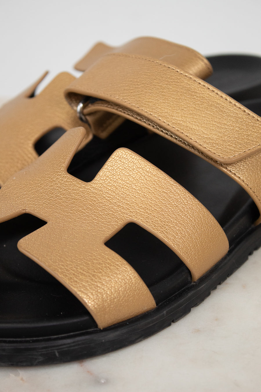 Close-up of gold and black sandal
