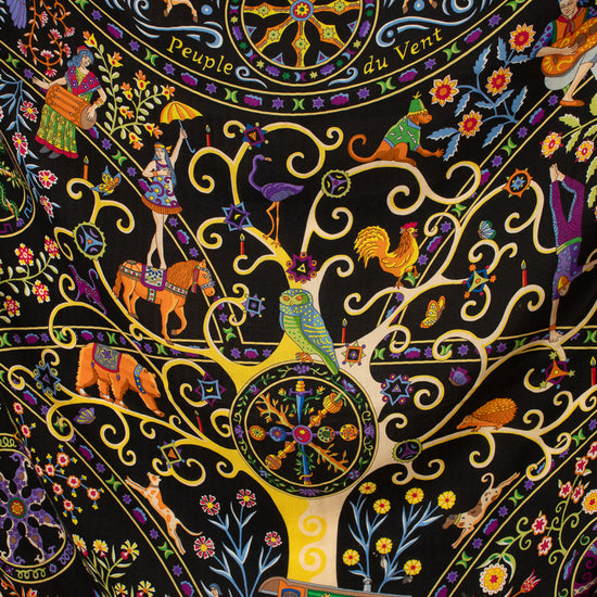 A close-up of a highly detailed, colorful Indian folk art textile scarf featuring a central tree motif with birds, horses, and decorative elements on a black background.