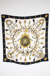 Decorative scarf with gold and black key pattern on a white background