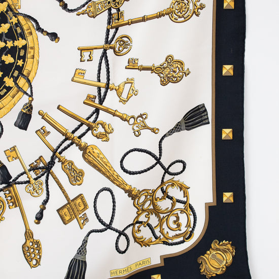 Designer scarf with gold keys and tassels print with a black border