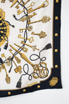 Designer scarf with gold keys and tassels print with a black border