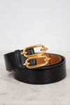 Black belt with a gold chain buckle on a light background