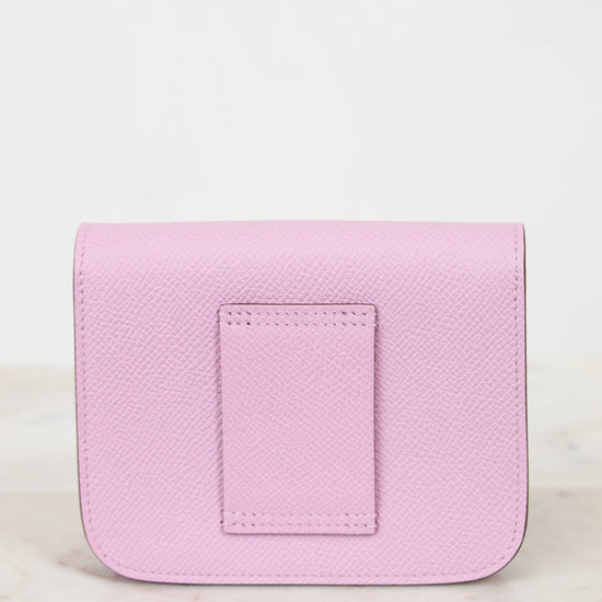Pink leather wallet on a light marble background