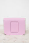 Pink leather wallet on a light marble background