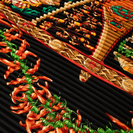 Hermès scarf with intricate design featuring peppers and braided patterns.