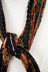 Colorful woven belt with a knot on a white background