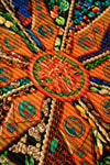 Close-up of a colorful embroidered textile with intricate patterns