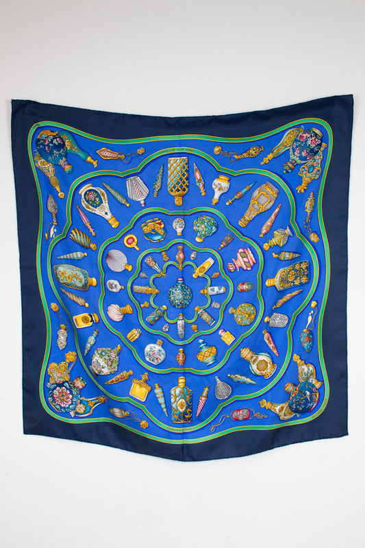 Decorative scarf with intricate patterns on a blue background
