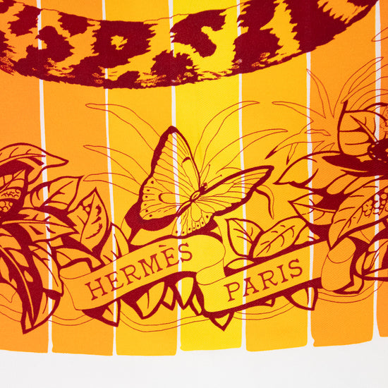 Hermes Paris scarf with leopard print and butterfly design on a yellow background