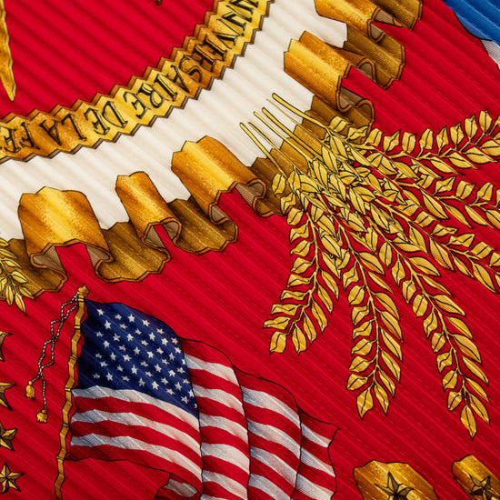 Close-up of a military emblem with gold details, American flag, and red background