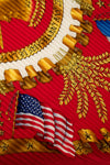 Close-up of a military emblem with gold details, American flag, and red background
