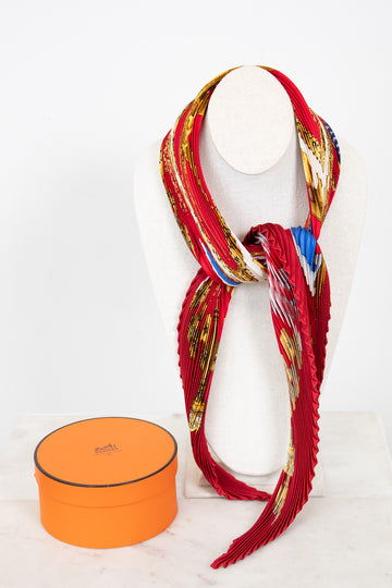 Colorful scarf on a necklace bust with an orange box on a white background
