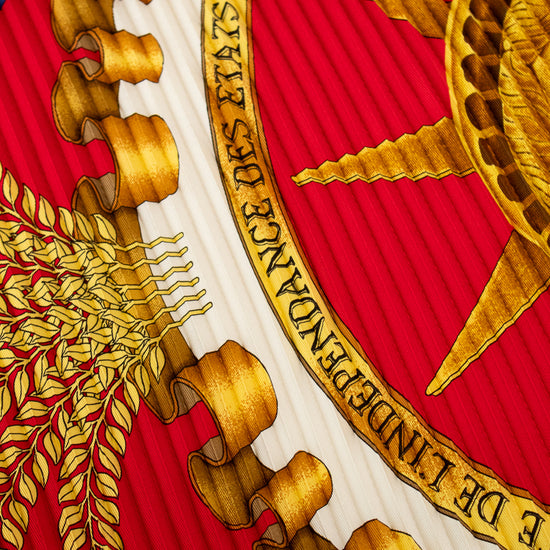 Close-up of a coat of arms with gold and red colors, featuring an eagle and a shield.