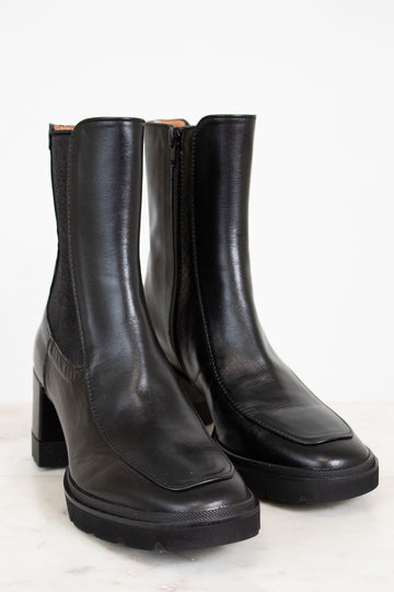 Pair of black leather boots on a white background
