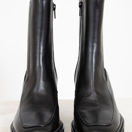 Pair of black leather boots on a white background