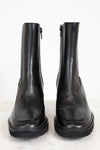 Pair of black leather boots on a white background