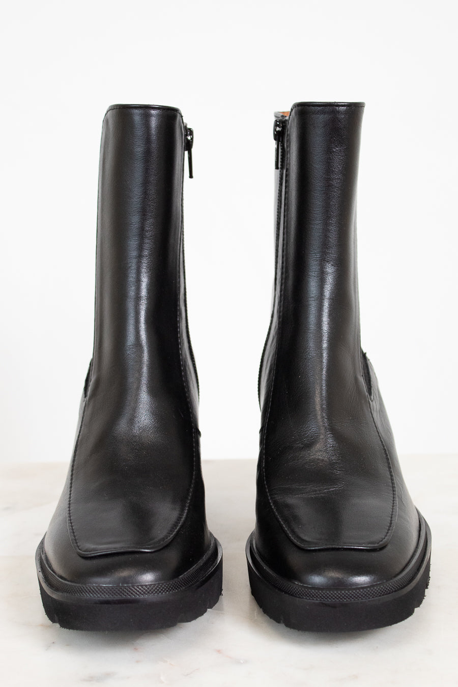 Pair of black leather boots on a white background