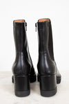 Pair of black leather boots on a white background