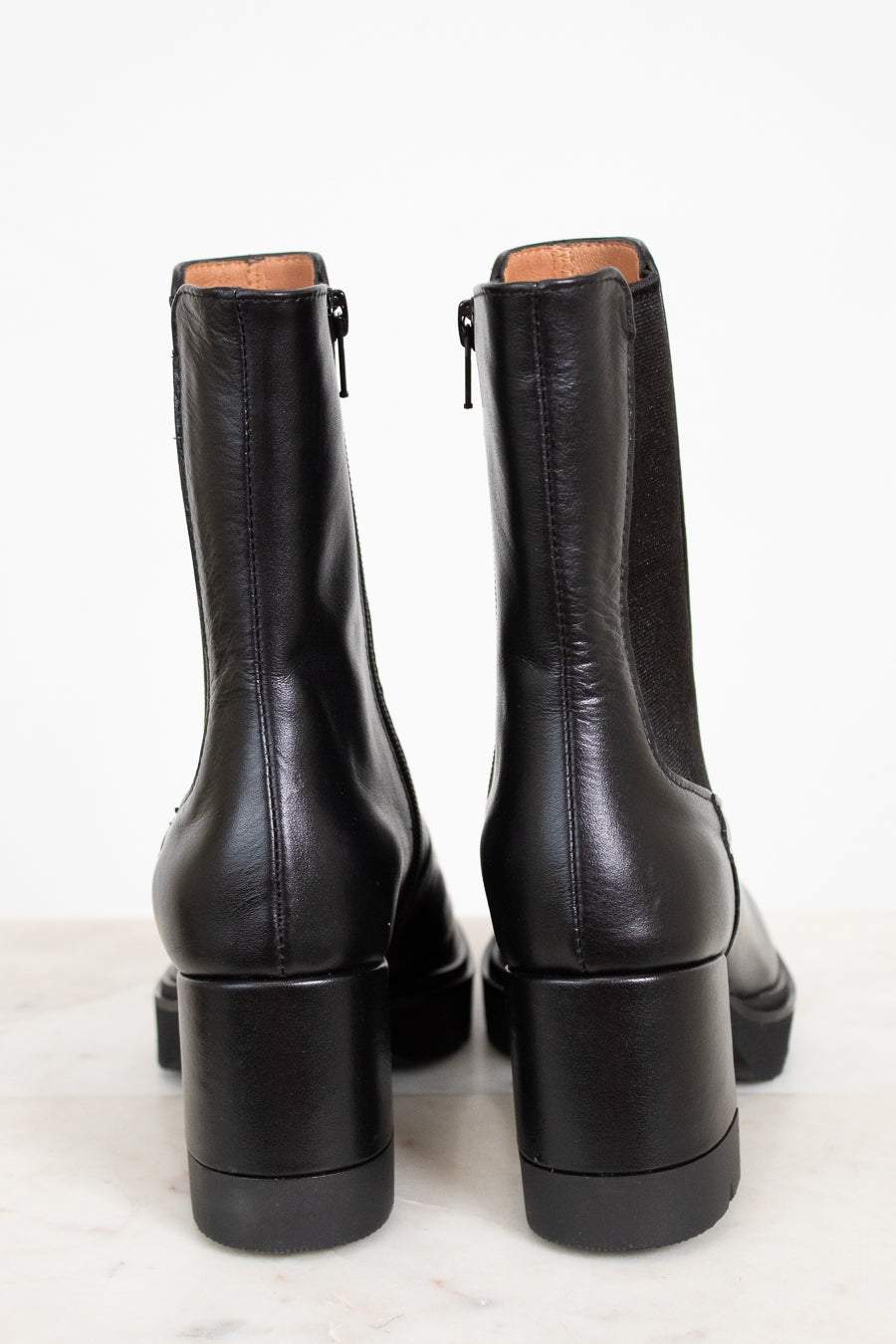 Pair of black leather boots on a white background