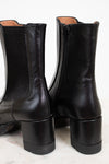 Pair of black leather boots on a white background