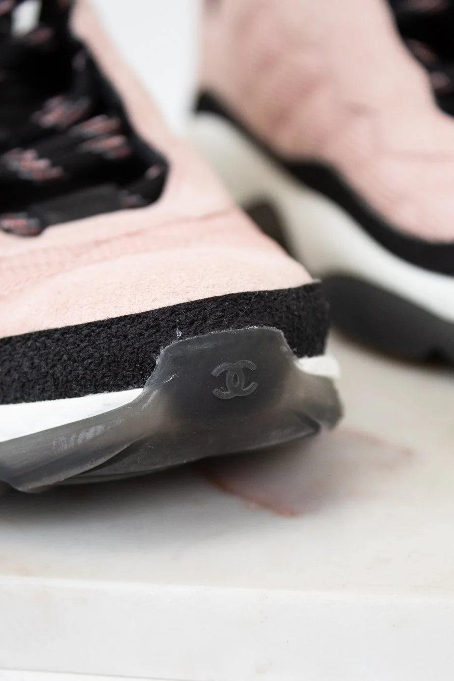 Close-up of a Chanel sneaker with a blurred background