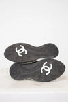 Black soles of shoes with white logo on a white background