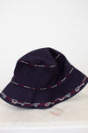 Navy bucket hat with decorative trim on a white background