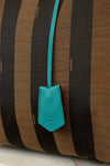 Brown and black striped bag with a turquoise Fendi tag.