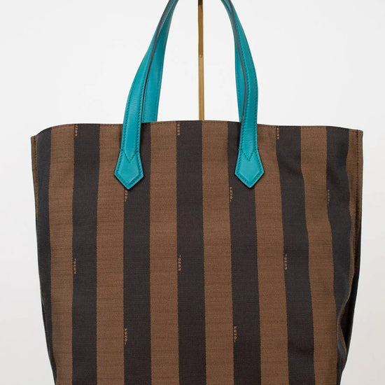 Striped tote bag with teal handles on a white background
