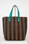 Striped tote bag with teal handles on a white background