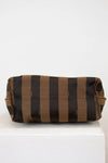 Striped fabric roll on a white surface with a light gray background