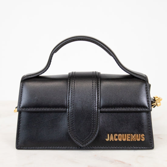 Black handbag with 'Jacquemus' branding on a white background