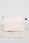 White clutch bag with gold and silver accents on a light gray background