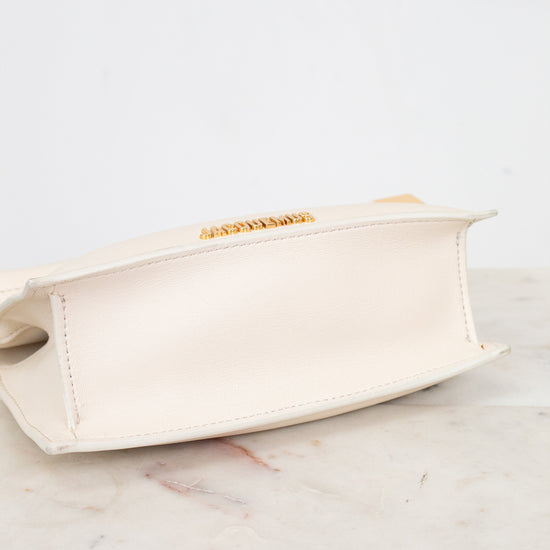 Beige clutch bag on a marble surface