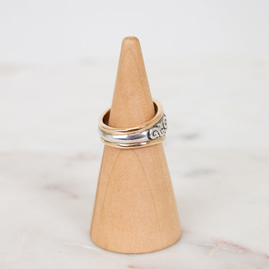 Ring on a wooden cone against a marble background