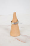 Ring on a wooden cone against a marble background