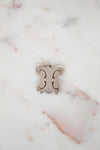 Silver butterfly pendant on a marble background