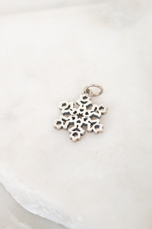 Silver snowflake pendant on a white background