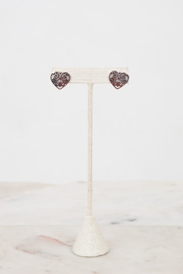 Heart-shaped earrings on a white stand with a white background