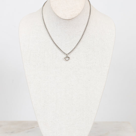Necklace on a mannequin bust against a white background