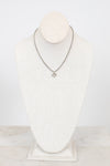 Necklace on a mannequin bust against a white background