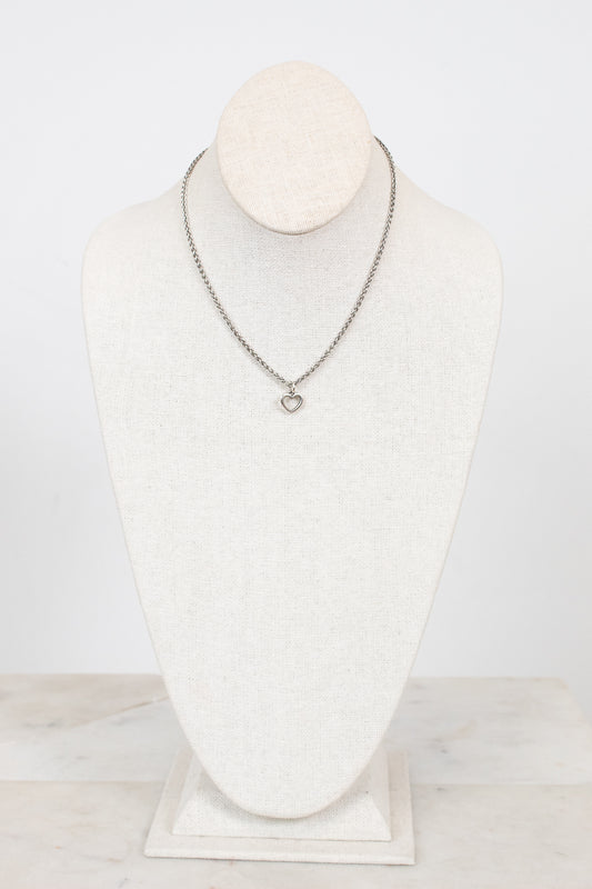 Necklace on a mannequin bust against a white background
