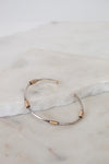 Gold and silver bracelet on a marble surface