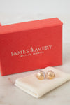 James Avery earrings on a white cloth with a red box in the background