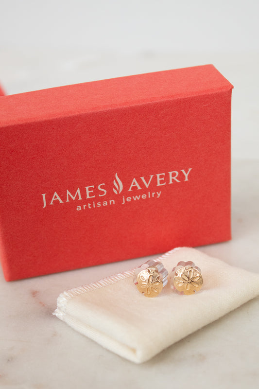 James Avery earrings on a white cloth with a red box in the background