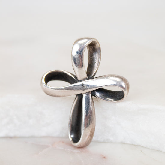 Silver cross pendant on a white background