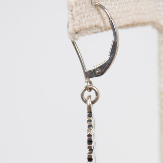Silver earring on a white background