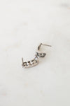 Silver earring on a white background